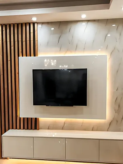 A sleek and glossy white TV unit with wood slat accents. The backlighting creates a beautiful ambient glow, perfect for movie nights.