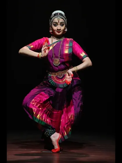 A classic pose from a solo recital, showing the traditional costume and ornamentation in detail.