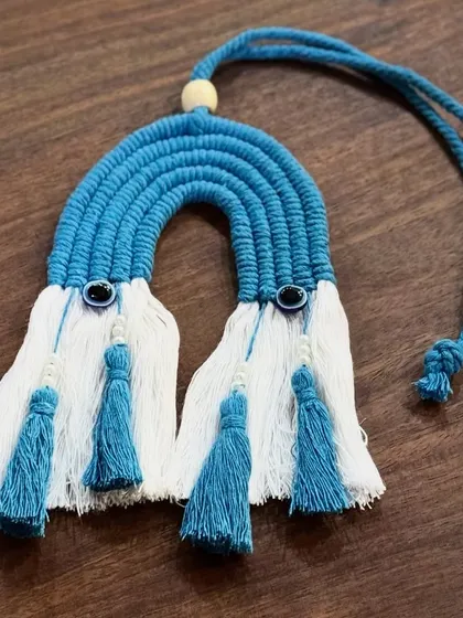 Another angle of the blue rainbow car charm, showing the detail of the evil eye beads and the neat tassels.
