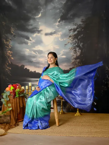 This series of portraits showcases the elegance of a maternity shoot in a saree. The flowing pallu and the rich colors of the silk create a stunning visual.