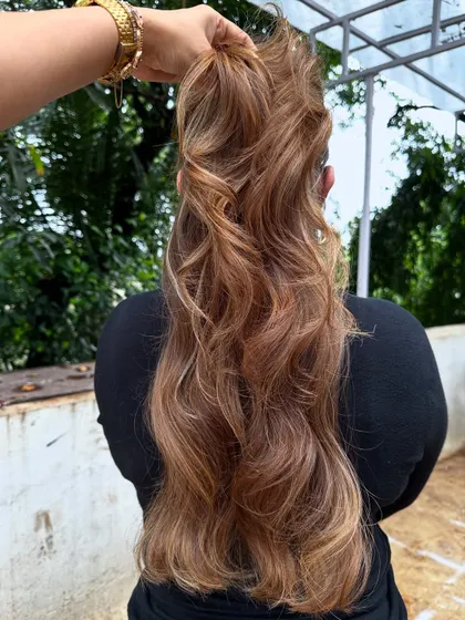 Holding up the hair to show the length and the beautiful, cascading blonde highlights.