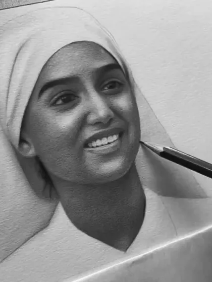 A close-up of the shading process on the face, using a pencil to build up smooth layers of graphite.