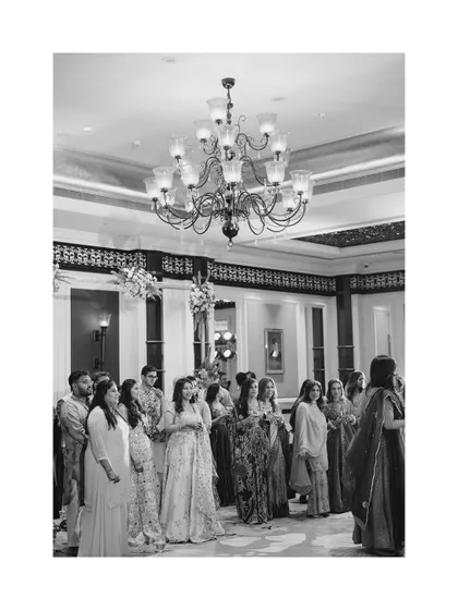 A black and white shot of the wedding guests, capturing the atmosphere and the elegant attire of the attendees.