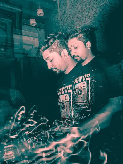 An artistic long-exposure shot by a talented photographer, capturing the dual nature of being a DJ. In the mix and in the moment.