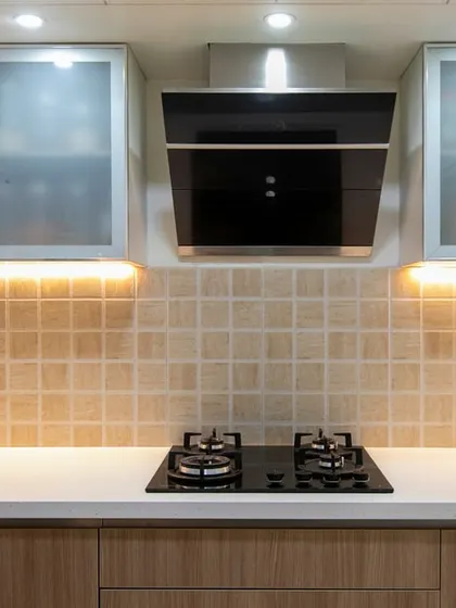 The textured beige backsplash adds depth, while under-cabinet lighting enhances both functionality and ambiance in this kitchen with smart storage solutions.