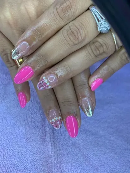 A fun and bright design with pink nails and accent nails featuring a plaid pattern and pearls.