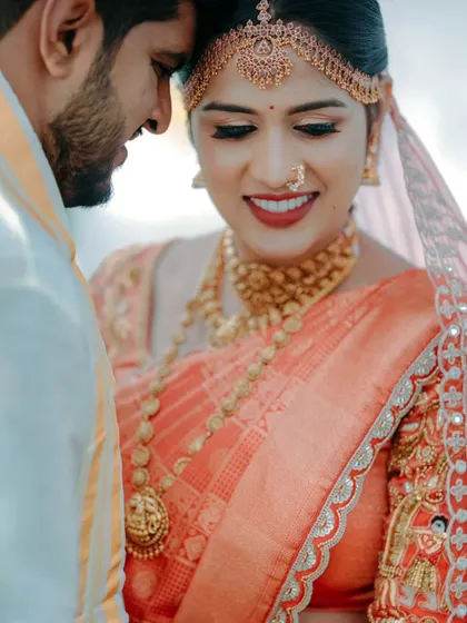 An intimate close-up of a bride and groom, their foreheads touching, capturing a moment of pure love and connection on their wedding day.