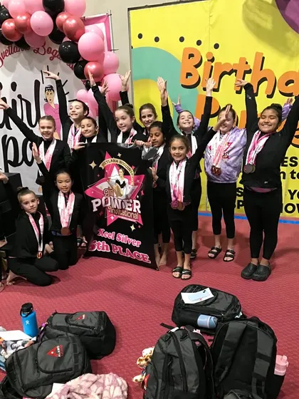 Pure joy! Our Xcel Silver team celebrates their 5th place award at the invitational.