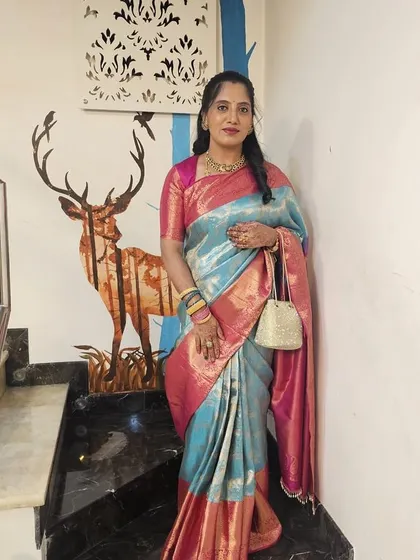 Vijetha's full look, complete with a traditional potli bag, perfect for a wedding or festive event.