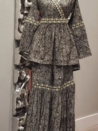 A lovely peplum-style sharara set in a subtle floral print. The angrakha-style top and tiered sharara pants make for a very flattering silhouette.