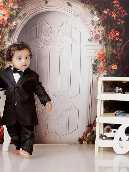 A dapper little gentleman. This portrait of Naksha in a tiny tuxedo by a miniature piano shows another one of our creative studio setups. I love creating these imaginative scenes for pre-birthday photoshoots.