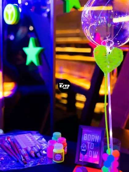 A 'Born to Glow' art station, with neon paints and brushes for guests to get creative.