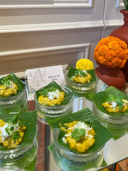 Bhutte Ke Kees served on individual banana leaf portions. This traditional dish was part of our special Ganesh Chaturthi menu, offering authentic flavors with an elegant presentation.