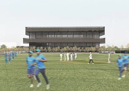 A view of the sports block from the practice grounds. The building's strong horizontal lines and deep cantilevers provide shade and create a dynamic presence, serving as a hub for athletes with facilities for training, recovery, and socializing.