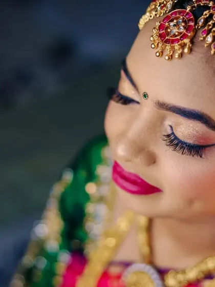 A close-up of the bride's beautiful makeup and traditional headpiece.