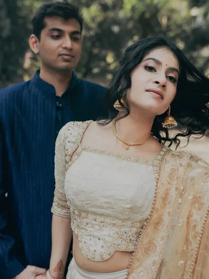 A modern and chic engagement portrait. The makeup is minimal and fresh, with a focus on clean skin and softly defined eyes, letting her natural beauty shine.