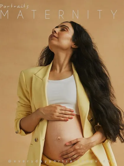 A modern and stylish maternity portrait. The yellow blazer adds a pop of color and confidence, showing that maternity wear can be chic and powerful.