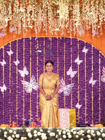 A wider shot of the bride on the same magnificent stage, looking like royalty.