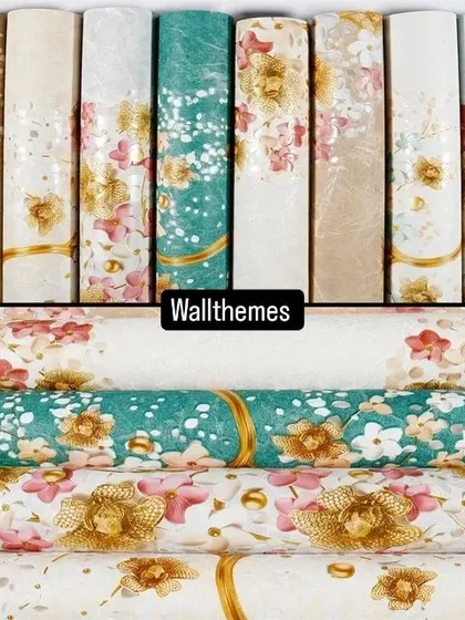 A collection of floral wallpaper rolls in various colors and patterns, showcasing the available variety.