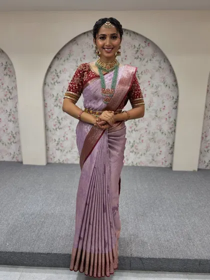 A happy client ready for her event. This shows how the complete look, from makeup and hair to the saree drape, comes together to create a radiant and confident appearance.