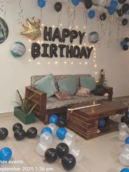 Another view of the blue, black, and white birthday room decoration. The setup is perfect for a surprise party at home.
