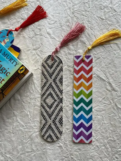 A set of wooden bookmarks with geometric and rainbow chevron patterns.