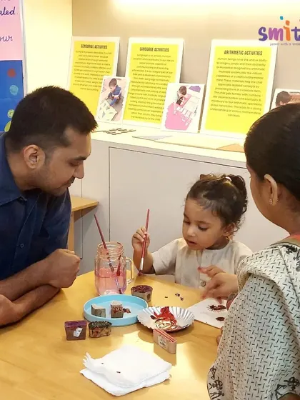 A family participates in a creative art activity together during an open house. We believe in making parents partners in their child's learning journey.