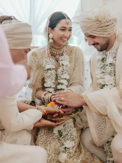 A beautiful, candid moment from Manchal and Luca's ceremony. The focus on their hands and the ritual objects highlights the cultural significance of the act.
