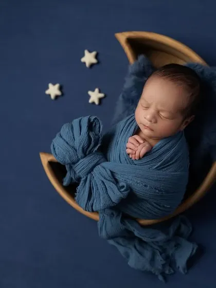A slightly different angle of the blue moon setup, showcasing the texture of the wrap and the baby's serene expression.