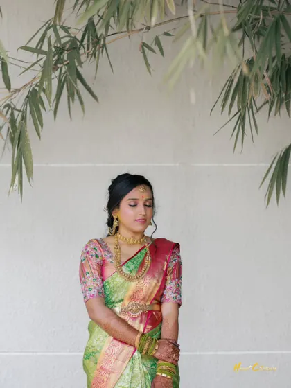 A peaceful outdoor portrait of the bride, with bamboo leaves creating a natural and serene frame.