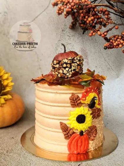 This "Beauti-FALL" cake is a whole-wheat pumpkin cake decorated with everything I associate with Autumn. It features buttercream sunflowers, a candied apple, and a fondant turkey.