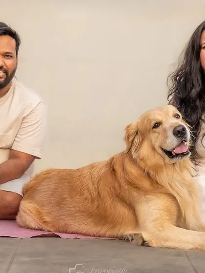 A complete family portrait with a golden retriever and two pugs. It's a joy to capture the unique dynamic of a multi-pet family.
