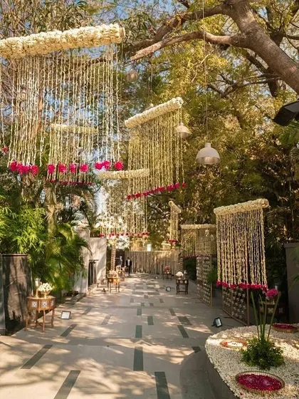 An elegant pathway lined with hanging floral chandeliers made of jasmine, creating a fragrant and magical walkway.