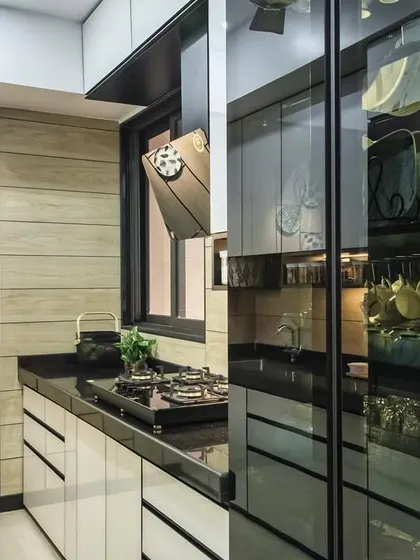 This shot showcases the integrated glass pantry unit in the Lodha Park kitchen, which serves as both storage and a design feature.