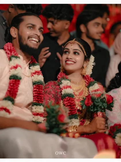 A candid shot of the couple enjoying their wedding ceremony, their faces lit up with happiness.