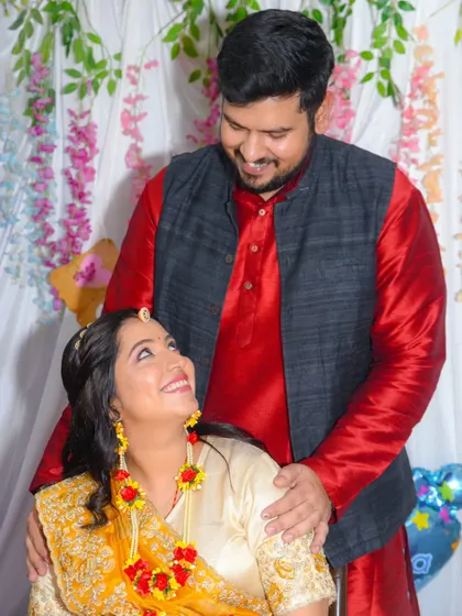 A candid, romantic moment captured during a baby shower photoshoot. The couple shares a look of love amidst the celebration.