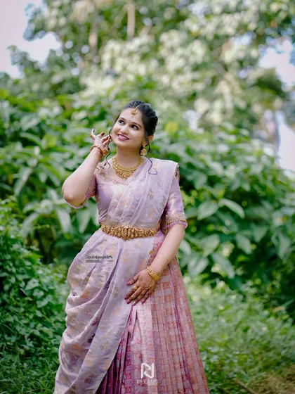 Our client Rishika looking absolutely stunning on her engagement day in a beautifully designed pastel half saree.