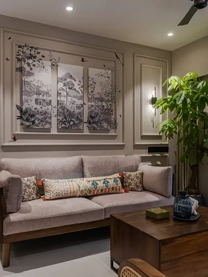 A close-up of the living area, highlighting the beautiful wall moulding that frames a triptych of art. This detail showcases our ability to integrate architectural elements with our bespoke furniture for a fully realized interior.