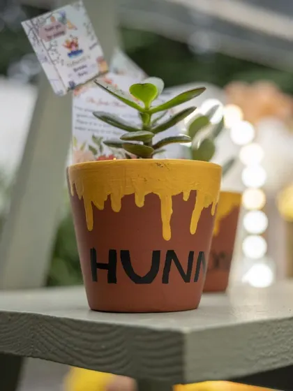 A 'Hunny' pot return gift for the guests. These small, themed thank-you gifts are a wonderful way to share the sweetness of the day.
