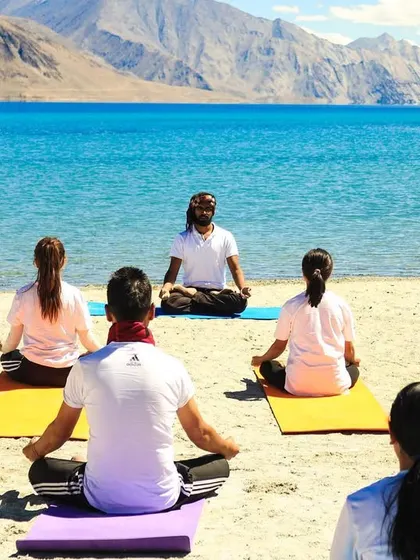 A view of my yoga class from behind the students, as they face me and the lake.