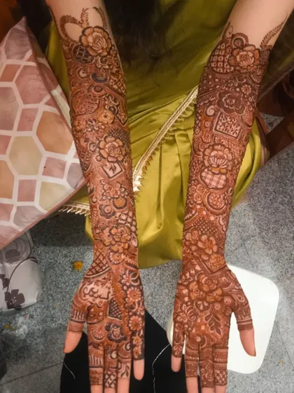 Henna love is real with this full bridal design. The arms are covered in a beautiful mix of floral and traditional patterns, perfect for a bride's special day.