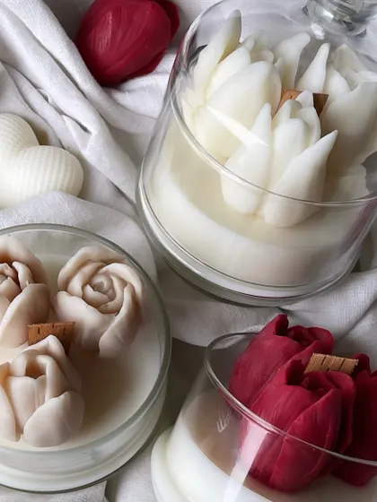 A close-up of the white tulip jar candle with a cloche lid. It's a beautiful and elegant decor piece.