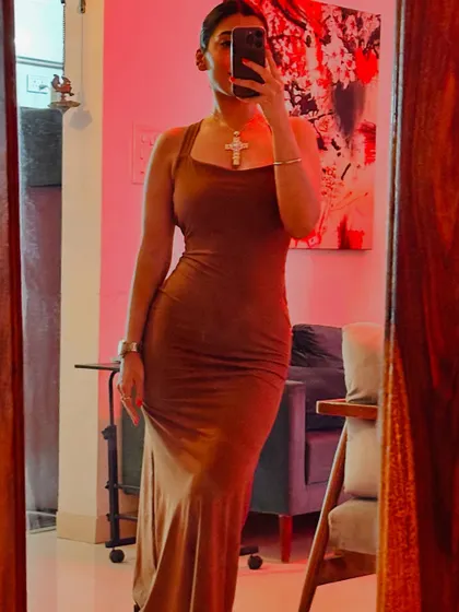 Here is an example of a more dramatic or edgy personal style. A form-fitting brown dress with a statement cross necklace. It's about finding what makes you feel most confident.