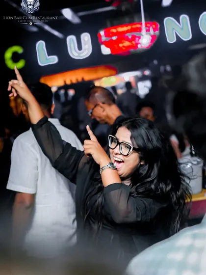 A partygoer at Lion Bar pointing right back at the DJ booth, feeling the connection.