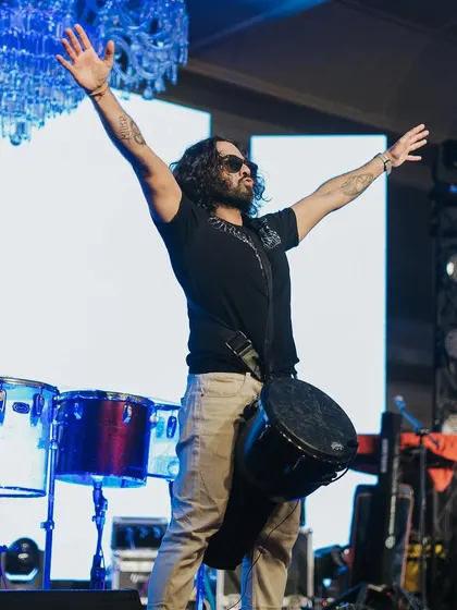 A percussionist hyping up the crowd, adding another layer of live energy to the Sangeet night.