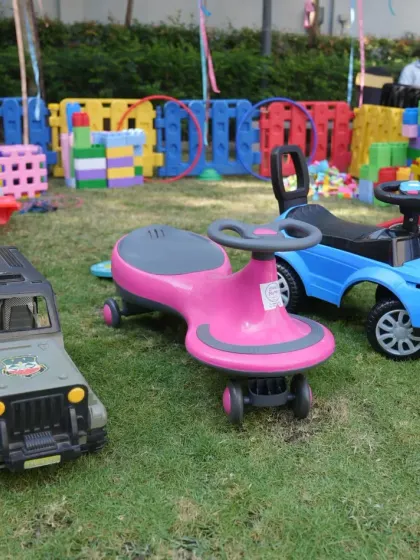 We offer a variety of ride-on cars and toys for toddlers and young children. This selection of jeeps and wiggle cars creates a mini race track area, perfect for an outdoor kids' party.