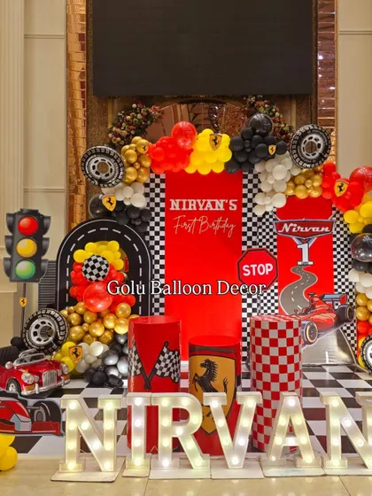 Another angle of the dynamic Ferrari stage setup, highlighting the traffic light prop and layered balloon garlands.