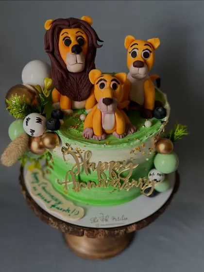 This anniversary cake tells the story of a family, with a lion, lioness, and their cub all hand-sculpted from fondant. It's a sweet and personal way to celebrate a family's bond.