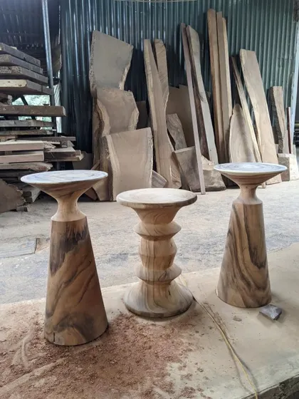 Three different styles of solid wood side tables in progress. Each one is hand-carved and shaped in my workshop to create a unique, artistic piece.