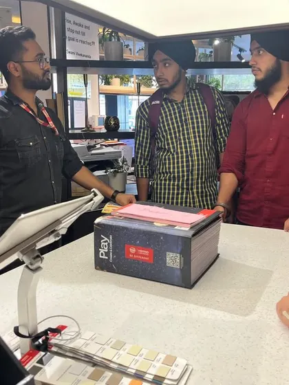 Students engage with a sales executive at the Merino Experience Centre, asking questions and gaining deeper knowledge about product applications.